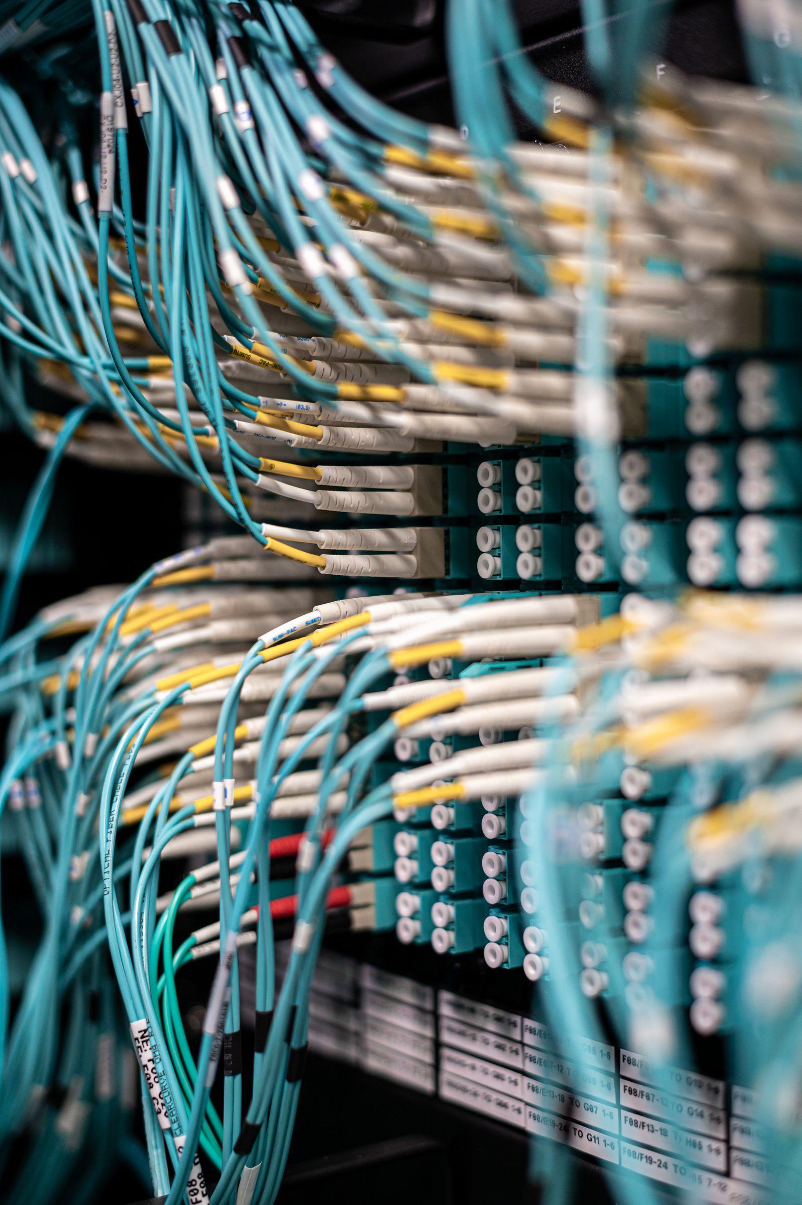 Fiber patch panel with teal cabling in a rack